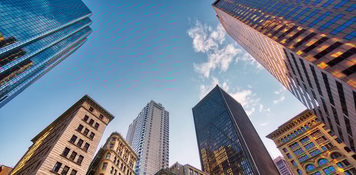 A skyline view featuring tall buildings against a clear blue sky in an urban setting.