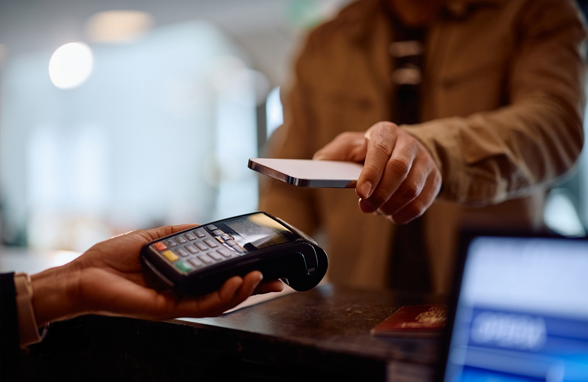 Contactless payment being made with a smartphone at a point-of-sale terminal.