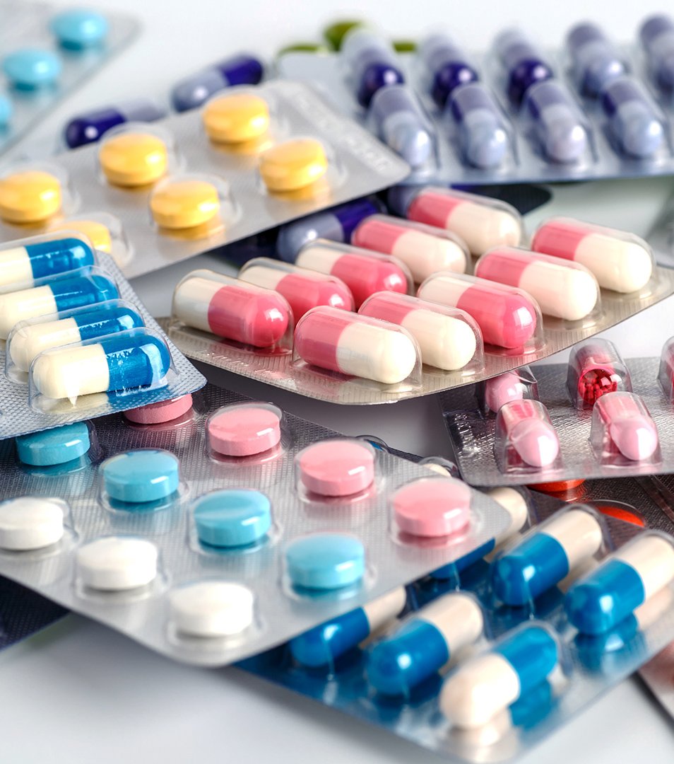 Assorted blister packs containing colorful capsules and tablets in various shapes and colors.
