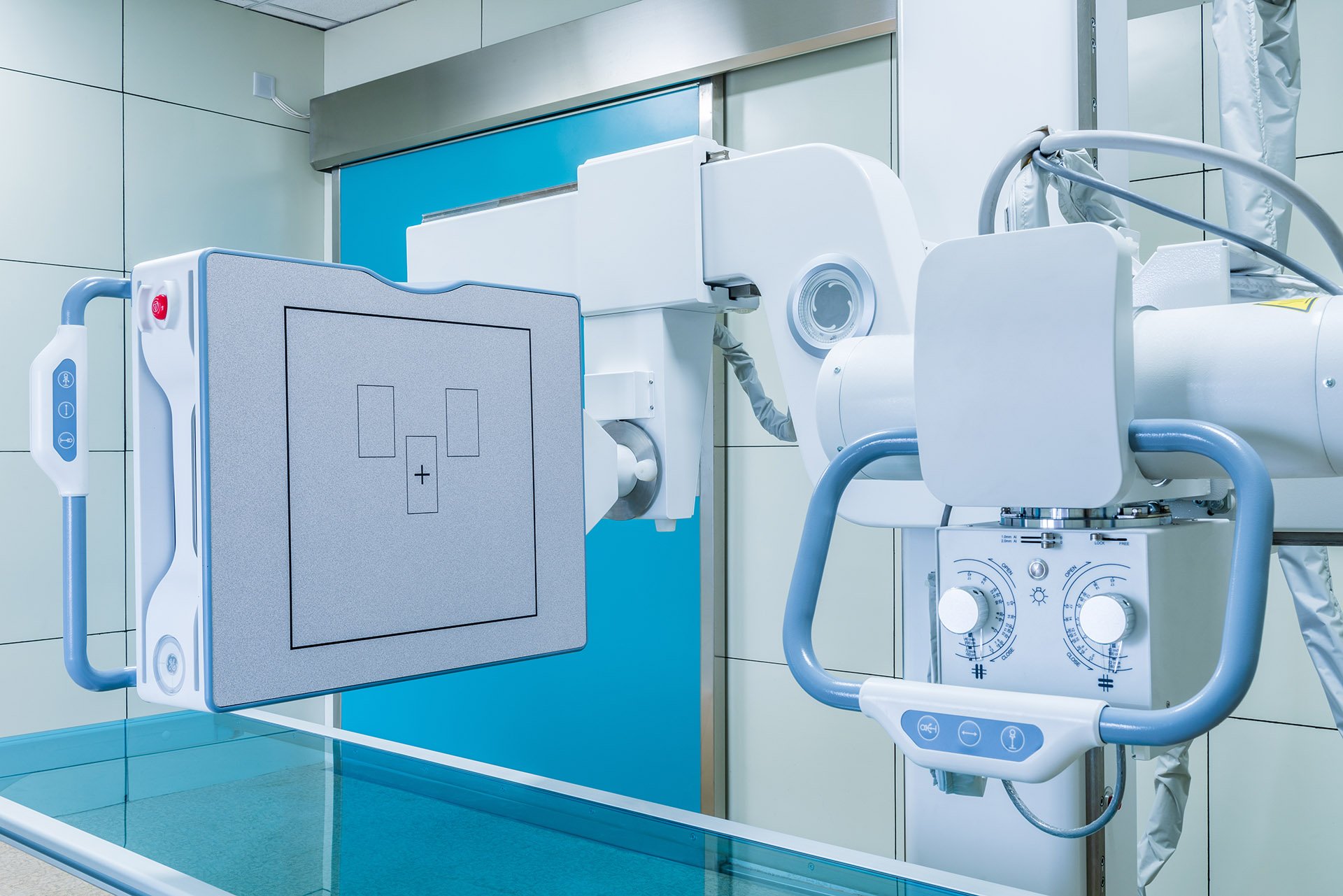 Modern medical X-ray machine in a hospital imaging room.