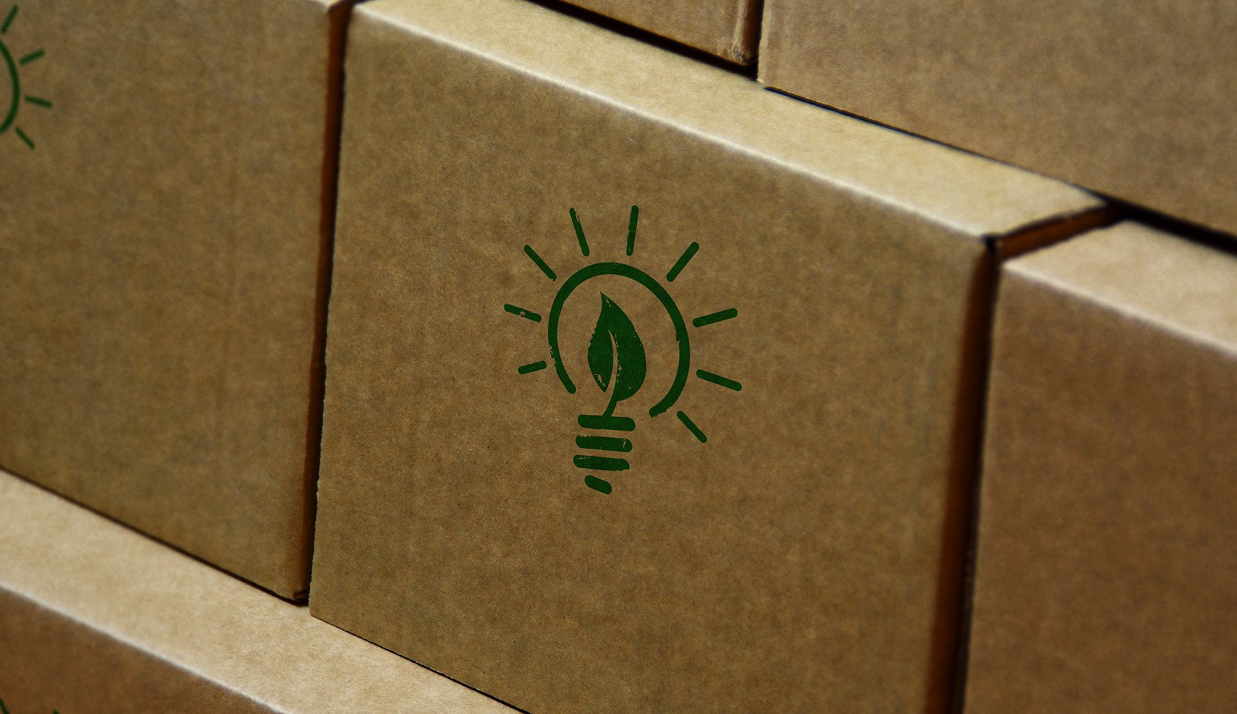 Close-up of a box featuring a green light bulb on top, highlighting its eco-friendly design.