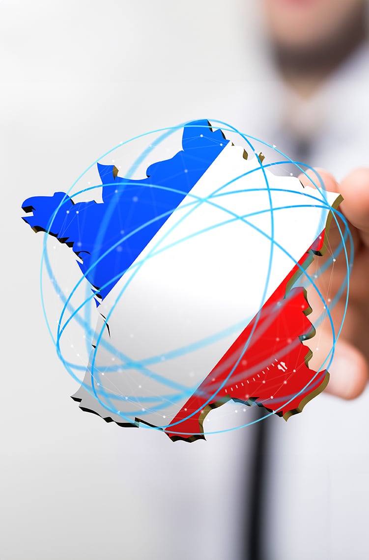 A human hand holds a 3D map of France, colored in blue, white, and red, surrounded by digital connectivity lines representing global links.