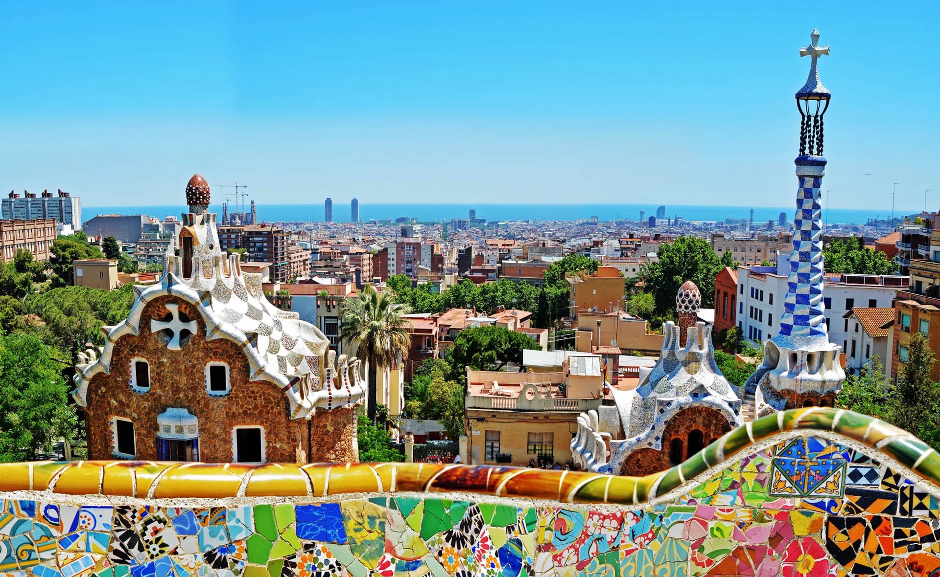 Vibrant buildings in Barcelona, Spain, showcasing a mix of architectural styles and colors under a clear blue sky.